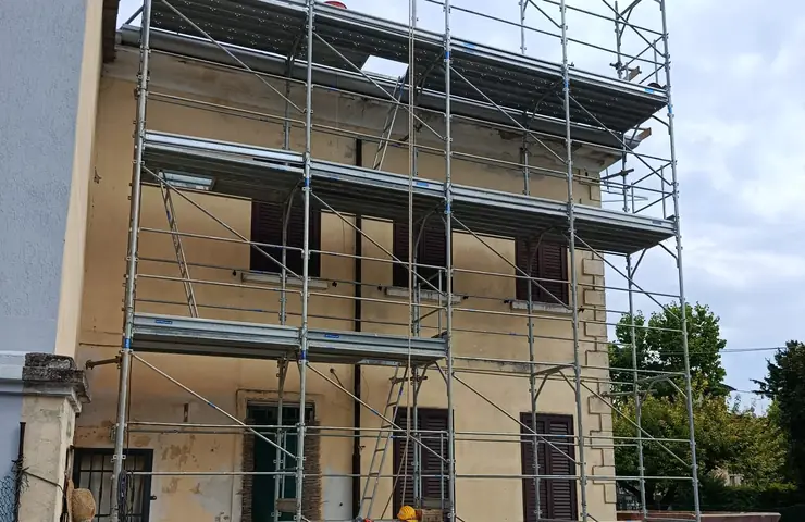 Casa con il ponteggio sulla facciata: cantiere di ristrutturazione D.EDIL